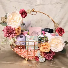 A beautiful and versatile 'Gift for Her' hamper. This floral metal basket is filled with skincare, cookies, and other pampering items, making it a perfect gift for a birthday, Mother's Day, or just because.