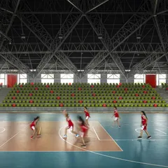 Athletes in motion on the basketball court of the 'Figured Ground' arena. The expansive interior is designed to facilitate a variety of sports, with durable surfaces and excellent lighting creating a professional-grade athletic environment.