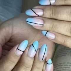 This design features a stunning airbrushed ombré effect, blending soft pink and baby blue. The look is made bold and modern with the addition of sleek, black strap-like lines painted over the gradient.