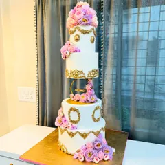 For grand celebrations, I create cakes that are as breathtaking as the moment itself. This four-tier floral wedding cake, with its floating tier and cascading handmade flowers, is a testament to timeless elegance.