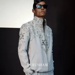This light grey bomber jacket is crafted from premium summer fabric and features intricate, swirling hand-embroidery. It exudes an air of effortless refinement, promising both comfort and style.