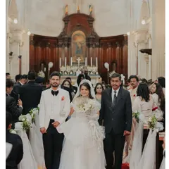 Walking down the aisle. Her makeup is subtle yet defining, ensuring she looks flawless and elegant for this most important walk.