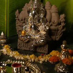 This Panch Mukhi Ganesha, embodying wisdom, prosperity, and protection, is a powerful centerpiece for any sacred space. Surrounded by a traditional pooja setup, this silver idol radiates positivity for Ganesh Chaturthi.