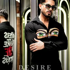 This shirt is designed to stare back. The front features a pair of hand-painted, piercing green eyes, while the back makes a bold statement: 'Haters Make Me Famous'. It's art with an attitude.