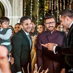 The groom's family shares a laugh as the ring mystery is solved. A great candid moment of family fun.