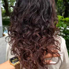 Curly and proud. I gave her curls a new life with a fresh cut, including a fringe, and subtle reddish-brown highlights to define the texture. Embracing your natural curls is always a good idea.
