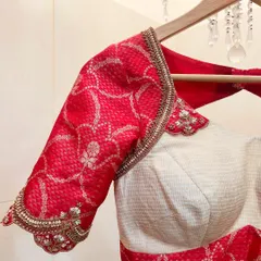 A classic combination of a crimson red and off-white blouse. We embellished this piece with Zardosi embroidery to pair perfectly with a gold-tone Mysore silk saree.