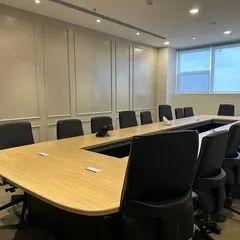 This conference room in Ambala is designed for productivity. It features a large U-shaped table to facilitate discussion, ergonomic chairs for comfort during long meetings, and classic wall paneling for a sophisticated look.