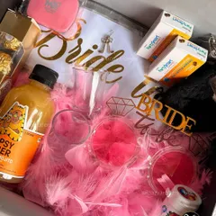 This bachelorette hamper is ready for the party. It's packed with a 'Bride' t-shirt, fun props, shot glasses, and other essentials for a memorable night with the girls.