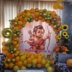 A birthday party with a 'Jai Shri Ram' theme. The custom banner and orange and yellow balloon arch are perfect for a celebration rooted in tradition.