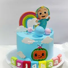 A cute and simple Cocomelon cake, perfect for a little one's celebration. This design features a hand-molded JJ, a bright rainbow, and edible name blocks, all on a delicious chocolate truffle cake.