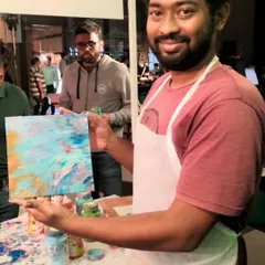 It’s not just for kids. I create a relaxed space where adults can also reconnect with their creative side. This gentleman was so proud of the abstract piece he made at one of my fluid art pop-ups.