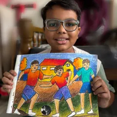 A student holds his memory drawing of boys playing football. Capturing action and emotion is a skill we develop for our exam preparation.