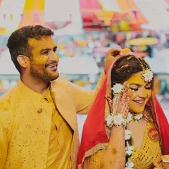 A tender moment during the Haldi ceremony. The groom gently applies haldi to his bride, a gesture full of love and tradition.