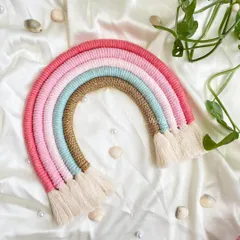This pastel macrame rainbow combines soft pinks and blues with a touch of sparkly gold jute for a gentle, elegant look. It’s a beautiful piece of wall art to add warmth to a nursery.