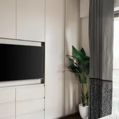 A side view showing how the entire built-in unit sits flush against the wall, extending right up to the window to maximize storage without overwhelming the room.