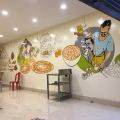 For this restaurant, we painted a full-wall illustrative mural capturing the essence of South Indian tiffin culture. The artwork features scenes of chai being poured, dosas being made, and customers enjoying their food, creating a warm and inviting atmosphere for diners.