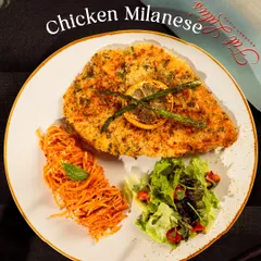 My Chicken Milanese is a crispy, breaded chicken cutlet served with a side of pasta and a fresh salad. It’s a hearty and complete meal.