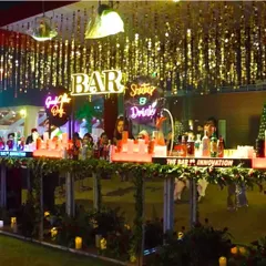 A great bar is the heart of any celebration. We designed and managed this stylish outdoor bar, complete with custom neon signs, an illuminated counter, and glittering overhead decor, ensuring the drinks and the good vibes kept flowing all night.