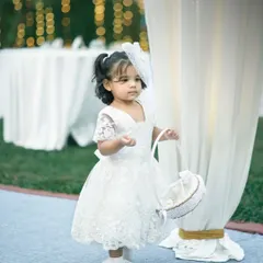 An adorable flower girl in her white lace dress, ready for her walk down the aisle. We capture all the charming details and participants of your wedding day.