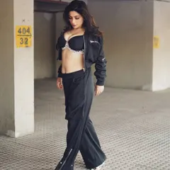 A walking shot that adds a sense of movement and narrative to the series. It feels like a candid moment captured on the streets of Mumbai.