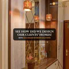 A glimpse into one of our client's homes, showcasing a stylish entryway with amber-colored pendant lights and a mirrored wall that adds depth and light.