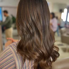 A beautiful Rich Roast color that looks so healthy and glossy. This subtle brown was achieved without any bleach, focusing on deep, warm tones that enrich the client's natural base color.