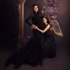 A magical moment between mother and daughter. The older sister, with sparkling fairy wings, gives her mom's baby bump a loving hug, ready to welcome her new sibling.