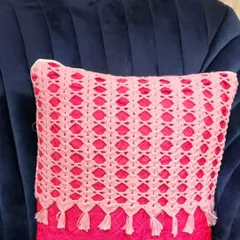 This is another one of my mesh design cushion covers, this time with a bright pink pillow inside. The tassels on the bottom make it look very stylish.