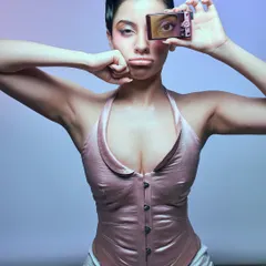 A playful and slightly rebellious portrait questioning the nature of art. The model holds a digicam, creating a meta-commentary on image-making in the digital age.