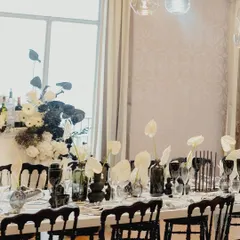A stunning black and white tablescape for a pre-wedding dinner in Lake Como. The dramatic black glassware and vases contrast beautifully with the delicate white anthuriums, creating a look of pure sophistication.