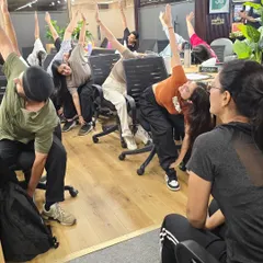 To combat the stiffness that comes from hours of sitting, I lead practical chair yoga sessions. These stretches are designed to be done at a desk, targeting common issues like backaches and tight shoulders.