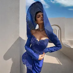 I believe in retelling tradition through structure. Here, an architectural mesh hood in a striking active blue replaces a conventional drape, creating a powerful, contemporary statement for the modern bride.