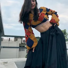 This full-length view shows how the #NoorTop pairs beautifully with a flowing black skirt. The cropped length and voluminous sleeves create a balanced and fashionable silhouette.