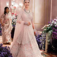 A grand entrance for a beautiful bride at her reception. The makeup is soft and ethereal, with a gentle shimmer on the eyes and a luminous complexion that glows under the lights, perfectly matching her Falguni Shane Peacock gown.