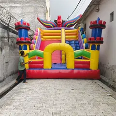 A colorful castle-style bouncy with unique winged details on the towers. This shows our ability to add custom decorative elements to our designs.