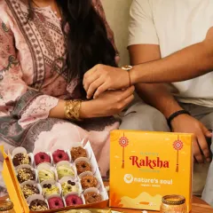 A heartwarming moment of a sister tying a rakhi on her brother's wrist during Raksha Bandhan, with a box of festive doughnuts ready to be shared.