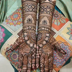 A classic full-hand mehendi design featuring graceful peacocks perched on the wrists and delicate lotus patterns, perfect for any grand celebration.