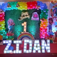 A close-up of the Cocomelon birthday decor we did at Celebration banquet hall. The bright colors, neon sign, and light-up letters create a super fun atmosphere for a kid's party.