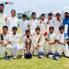 Our cricket team posing with their coaches after a great session. We foster a supportive environment where kids learn from certified coaches and build strong bonds with their teammates.