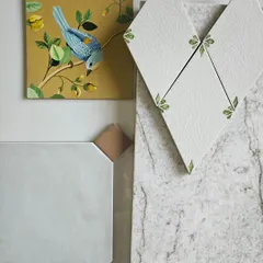 Here, I was playing with the idea of nature-inspired details. The hand-painted bird tile, the leaf-motif diamond tiles, and the textured stone sample create a story that is both whimsical and grounded in natural beauty.