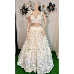 Feel like a dream in this ivory floral lehenga, perfect for a sangeet, reception, or a modern pre-wedding photoshoot. The delicate 3D floral appliqué and the unique one-shoulder blouse create a look that is both romantic and fashion-forward.