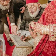 A sacred moment from a Nikah ceremony, as the bride signs the marriage register, witnessed by her elders. We capture these traditions with respect and an eye for detail.