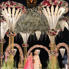 A grand mandap design featuring towering floral structures and cascading chandeliers. This setup is perfect for couples who want a lavish, opulent wedding ceremony that leaves guests in awe.