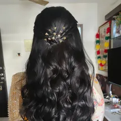 A detailed shot of the back of the hairstyle, showing the delicate hair accessory that completes the look.