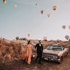 A candid moment of the couple walking hand-in-hand. The gown flows beautifully as they move, adding a touch of elegance to this adventurous shot in Turkey.