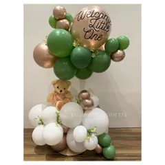 Tiny toes and big dreams! This "Welcome Little One" balloon bouquet in a soft green and rose gold palette is a chic and modern way to celebrate a new baby.