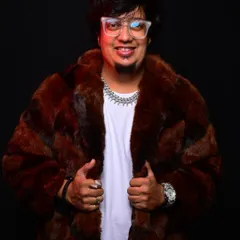Another shot in the fur coat, representing the confidence and style I bring to my work. I am always ready to take over the city with a great playlist.