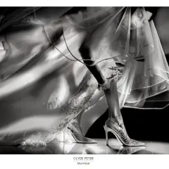 This Fearless Award winning photograph is an example of my artistic approach to wedding cinematography. I look for unique angles and lighting to turn ordinary moments into extraordinary images that tell a story. This shot captures the elegance and anticipation of the bride's final preparations.