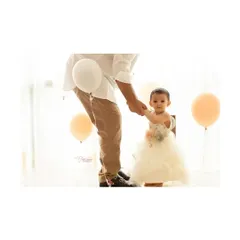 Those first wobbly steps, holding tight to daddy's hand. This is one of those blink-and-you-miss-it moments from a first birthday session that you will cherish forever.